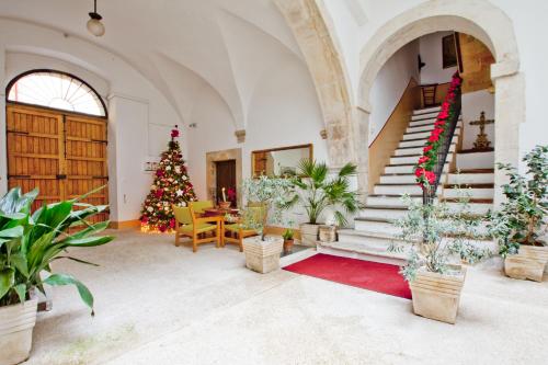 a living room with a christmas tree and stairs at B&B Il Marchese Del Grillo in Sulmona