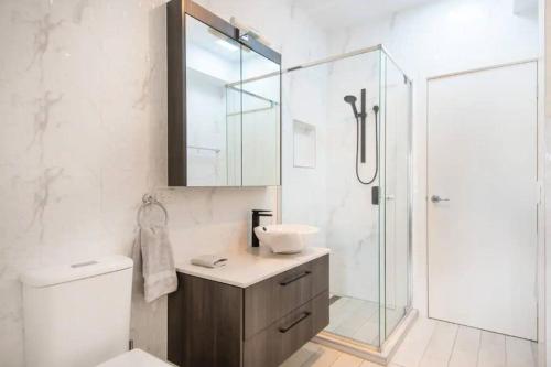 a bathroom with a shower and a sink and a toilet at Family Tides Beach House in Rosebud