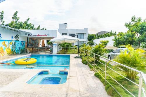 a swimming pool in front of a house at Casa finca con piscina in Santa Marta