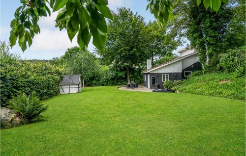 a yard of a house with a grass field at Amazing Home In Børkop With Wifi in Børkop