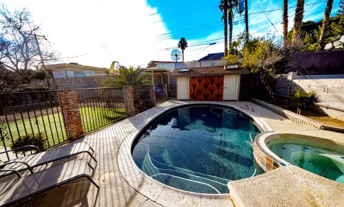 a swimming pool in front of a house at Newer Ranch with Pool and Hot Tub near the Strip and Freemont street. in Las Vegas