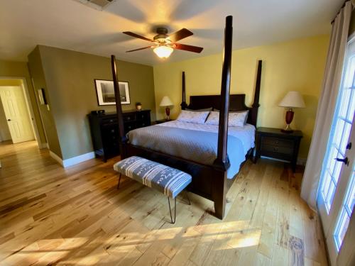 a bedroom with a bed and a ceiling fan at Newer Ranch with Pool and Hot Tub near the Strip and Freemont street. in Las Vegas