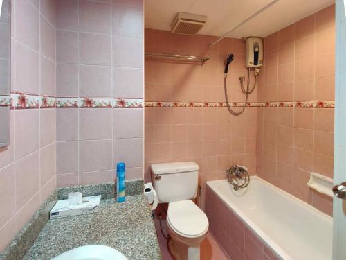 a bathroom with a toilet and a bath tub at Jomtien Beach Condominium S1 by Olga in Jomtien Beach