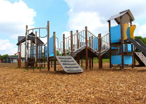 a playground with a slide in a park at Bosworth Lakeside Lodges 