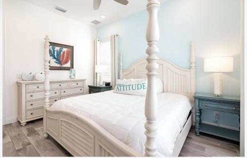 a bedroom with a white bed and a blue dresser at ZAY & ZAC’S SHAKE SHACK in Orlando
