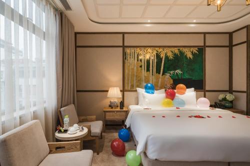 a hotel room with a bed with balloons on it at La Passion Hanoi Hotel & Spa in Hanoi