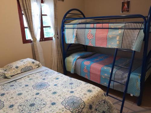 a bedroom with two bunk beds and a bed at Cabaña El Cielo de María in Boquete