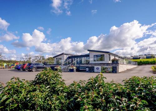 a building with a car parked in a parking lot at Crofthead in Ayr