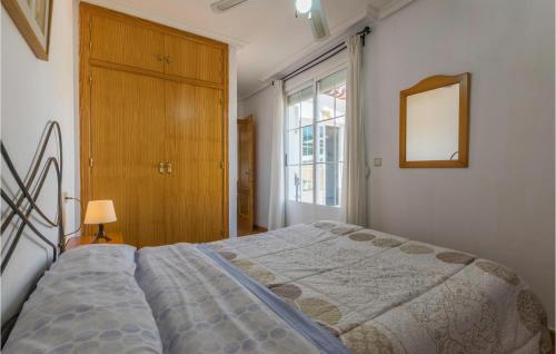a bedroom with a bed and a mirror and a window at Gorgeous Apartment In Puente De Genave With Sauna in Puente de Génave