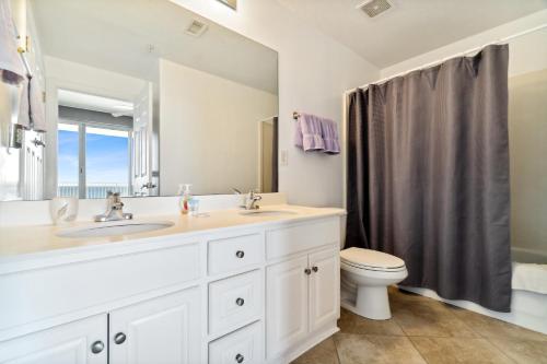 a bathroom with a sink and a toilet at Ocean Reef Beach Resort! Beach Front! Free Seasonal Beach Chairs! by Dolce Vita Getaways PCB in Panama City Beach
