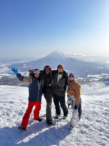a group of people standing on top of a snow covered mountain at TOTONOU Place in Asahikawa