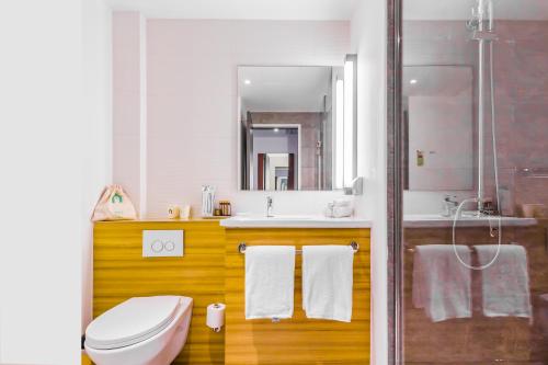 a bathroom with a toilet and a sink and a shower at Campanile Shanghai Railway Station and People's Square in Shanghai