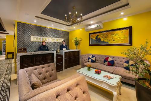 a living room with couches and a bar at Eden Boutique Hotel & Spa in Sa Pa