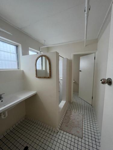 a bathroom with a sink and a mirror at The Espy Hostel in Cairns