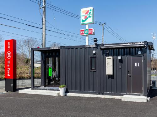 a black building with a sign on top of it at HOTEL R9 The Yard Iizuka in Iizuka