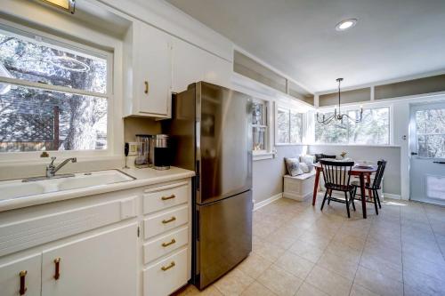 a kitchen with a stainless steel refrigerator and a table at Pet Friendly and Historic Prescott Home with Fire Pit! in Prescott