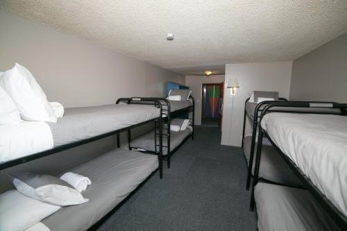 a room with three bunk beds and a hallway at Motel 6 - Las Vegas, NV – Downtown Fremont St Experience in Las Vegas