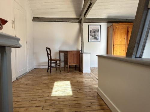 a hallway with a table and chairs in a room at Maison rénovée avec jardin clos, proche du centre historique, idéale pour famille ou télétravail - FR-1-489-439 in Moulins