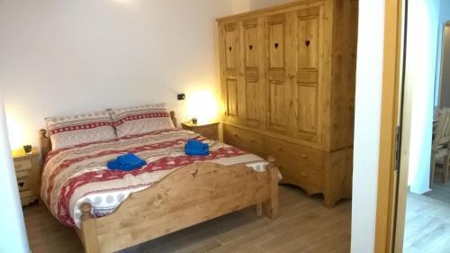 1 dormitorio con 1 cama y armario de madera en Pays du Grand St Bernard, en Saint-Rhémy
