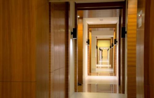 a hallway in a building with a mirror at Perfect Marina Stay @ Strait Quay 6 Pax Max in Bagan Jermal