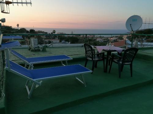 a tennis court with tables and chairs on a roof at CASA VERDE Inn in Ischia