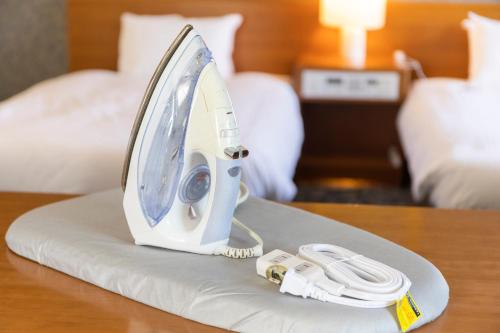 a iron sitting on a table in a hotel room at Yamagata Grand Hotel in Yamagata