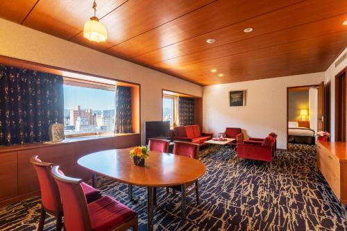 a hotel room with a table and chairs at Yamagata Grand Hotel in Yamagata