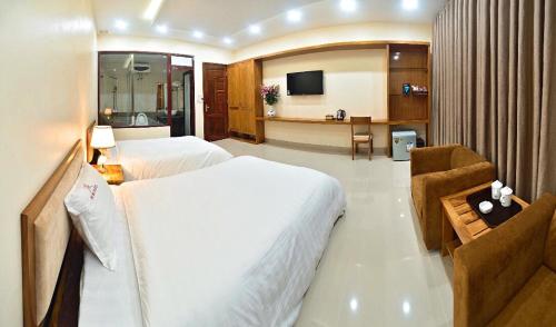 Ένα ή περισσότερα κρεβάτια σε δωμάτιο στο Ruby Hotel