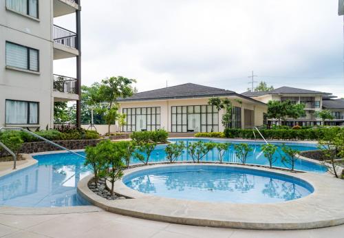 a swimming pool in front of a building at An Oasis in Tagaytay - Serin in Tagaytay