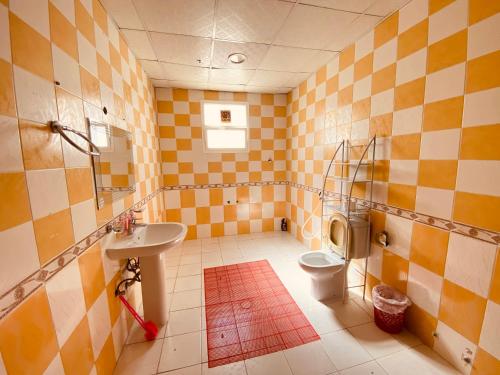 a bathroom with a toilet and a sink at Private Cottage in Sharjah