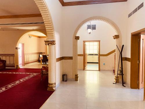 a hallway with an archway in a building at Private Cottage in Sharjah
