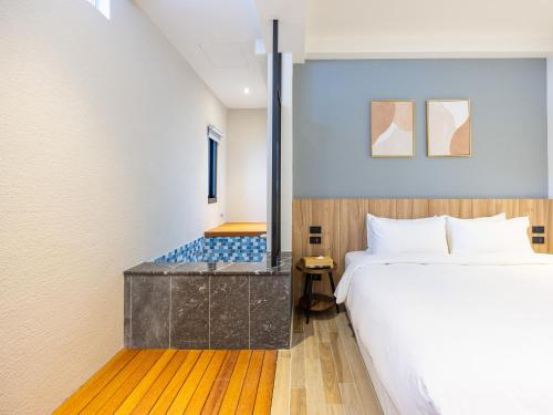 a hotel room with a bed and a shower at Kenting Sea Wall 130 in Kenting