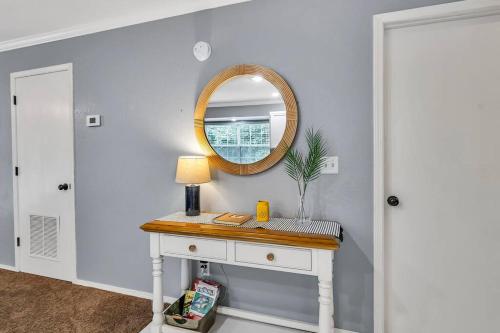 a dressing table with a mirror on a wall at Cozy Lakeside Getaway - Outdoor Theater - Free Early Check-In- 4min to Silver Dollar City in Branson