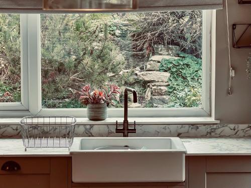 a sink in a kitchen with a window at Upalong in West Lulworth