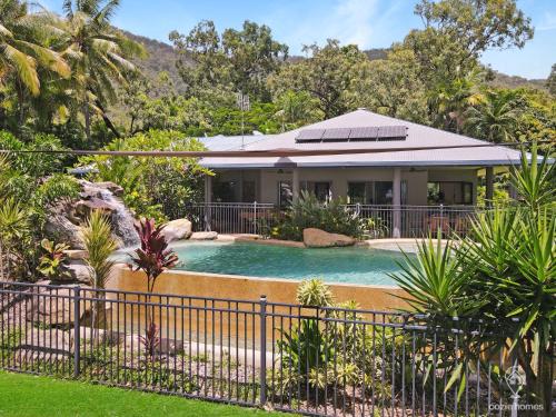 a house with a swimming pool in a yard at Heavens Gates - Privacy Near Ellis Beach in Wangetti