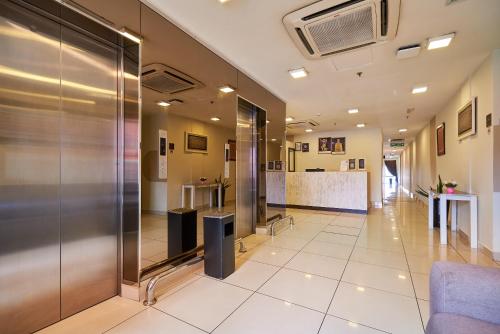 an office lobby with a elevator and a reception at Swing & Pillows - Adya Hotel Kuala Lumpur in Kuala Lumpur