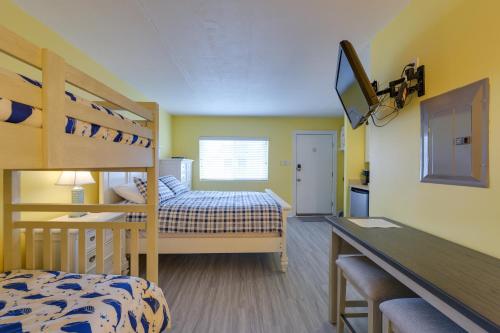 a bedroom with two bunk beds and a desk at Ocean City Condo with Pool Walk to Boardwalk! in Ocean City