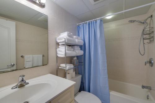 a bathroom with a sink and a toilet and a shower at Ocean City Condo with Pool Walk to Boardwalk! in Ocean City