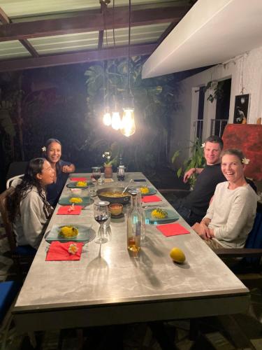 a group of people sitting around a long table at Bellevue Tamarin in Tamarin
