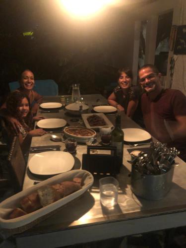 a group of people sitting around a table with food at Bellevue Tamarin in Tamarin