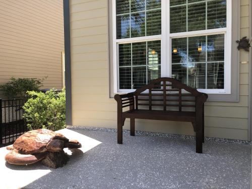 a large turtle sitting on the front porch of a house at HONU KAI - 3 Bedroom Townhouse townhouse in Jekyll Island