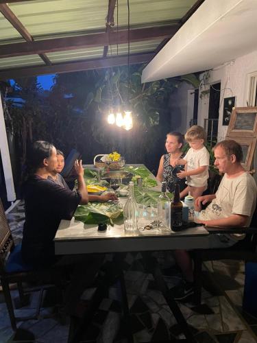 a group of people sitting around a table at Bellevue Tamarin in Tamarin