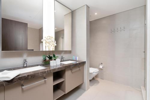 łazienka z 2 umywalkami i prysznicem w obiekcie Dream Inn Apartments- Boulevard Heights w Dubaju