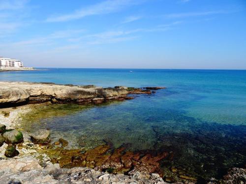 a view of the ocean with rocks and the water at Villa Longo de Bellis in Bari