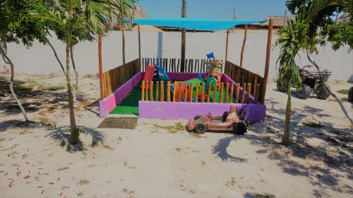 a childs playground on the beach with a toy car at Casa Frida in Chelem