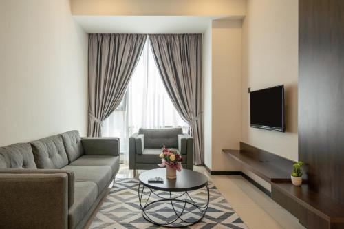 a living room with a couch and a table at Opus KL Residences by Premium Hospitality in Kuala Lumpur