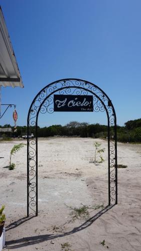 a metal gate in the middle of a beach at Casa Frida in Chelem