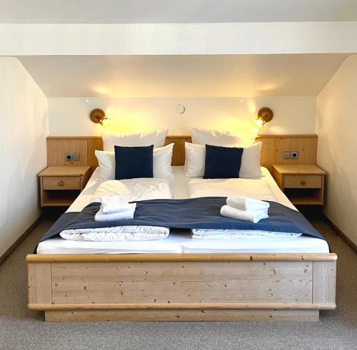 um quarto com uma cama grande e almofadas azuis e brancas em Haus Waltraud em Bad Wiessee