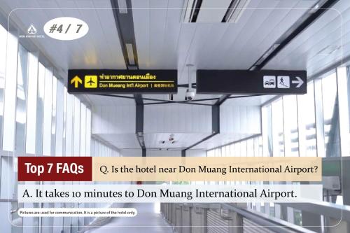 a sign hanging from the ceiling of an airport at Asia Airport Hotel in Bangkok