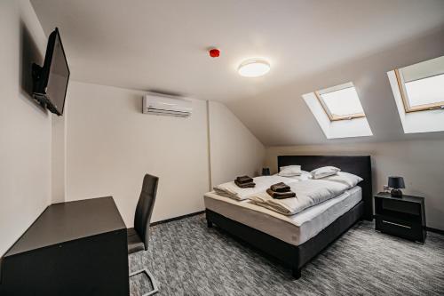 A bed or beds in a room at Cédrus Club Hotel